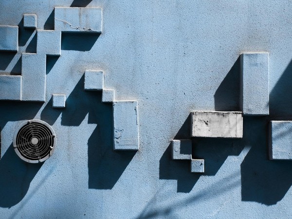 Abstract design of a blue wall featuring geometric shapes and shadows in China.